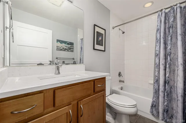 a bathroom with a sink toilet tub and shower
