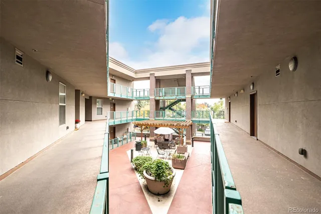 a view of a patio with couches table and chairs and potted plants