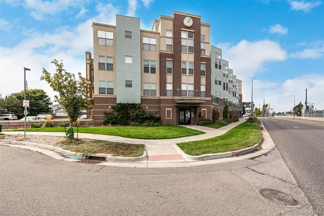 a view of a tall building next to a yard
