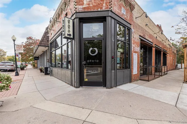 a view of a street with stores