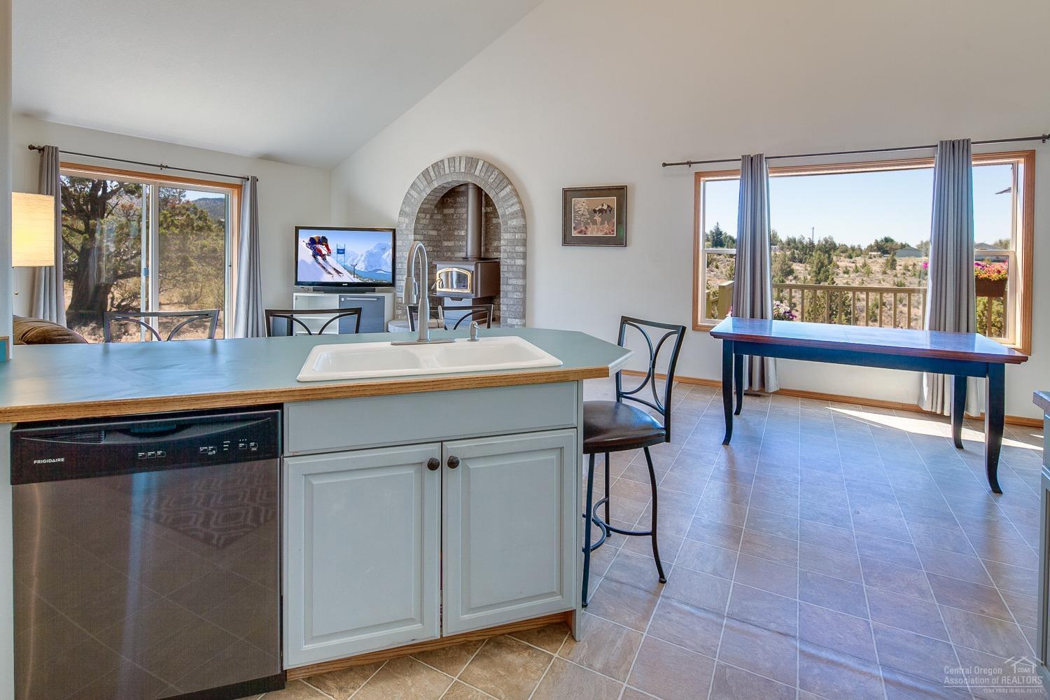 13990 South Sego Lily Road Powell Butte, OR 97753 - Photo 10 of 24 Family room features a wood-burning fire