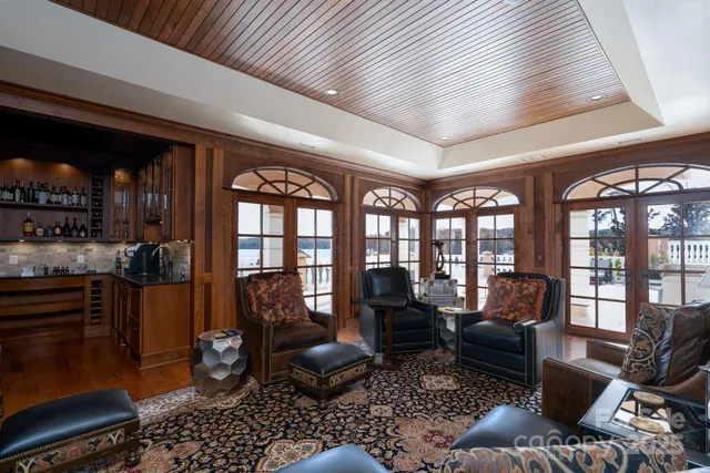 a living room with furniture and a floor to ceiling window