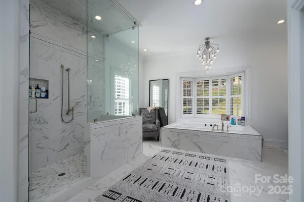a spacious bathroom with a tub sink and shower