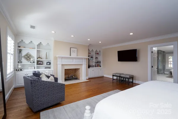 a living room with furniture wooden floor and a fireplace