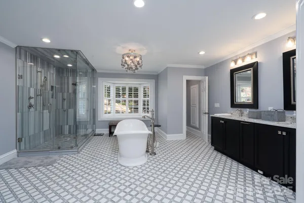 a large bathroom with a sink a toilet and shower