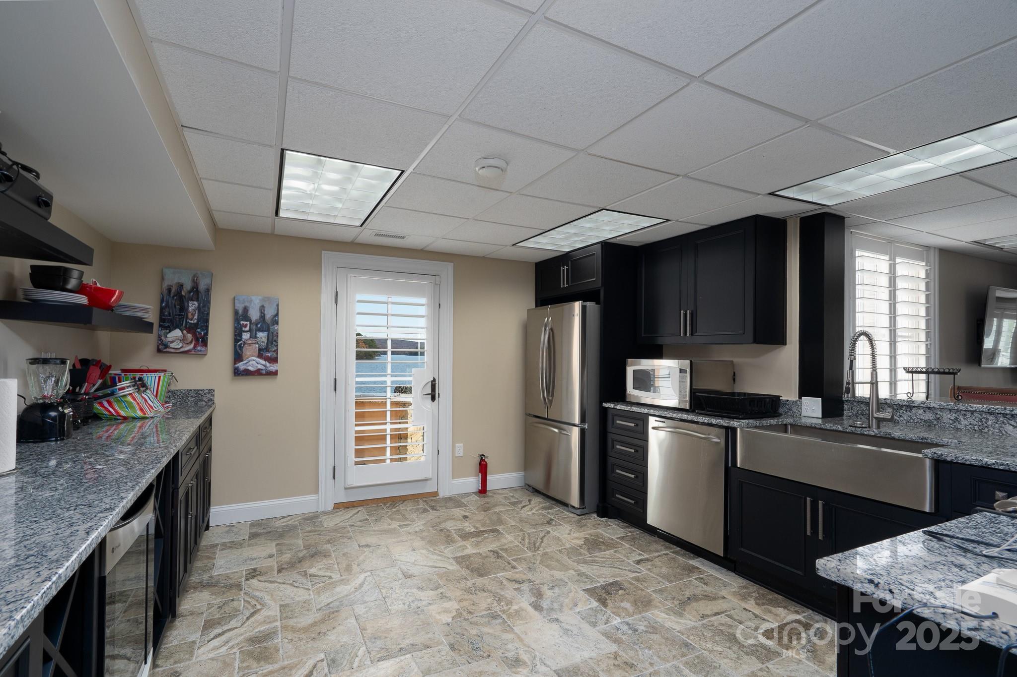 444 Glenbrook Spring New London, NC 28127 - Photo 40 of 48 a kitchen with stainless steel appliances granite countertop a sink stove and refrigerator