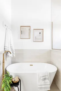a bathroom with a tub and a shower