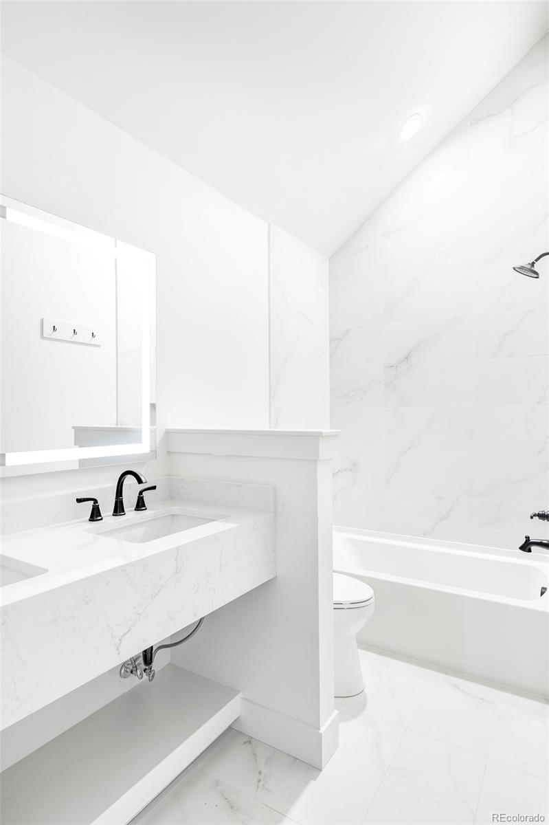 2914 Hooker Street Denver, CO 80211 - Photo 21 of 30 a bathroom with a sink and a bathtub