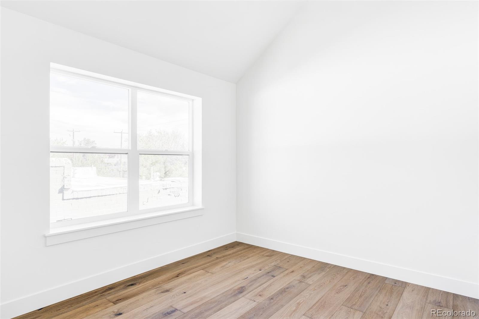 2914 Hooker Street Denver, CO 80211 - Photo 22 of 30 an empty room with wooden floor and windows