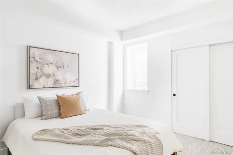 a large white bed in a white room