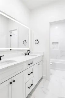 a spacious bathroom with a double vanity sink and mirror