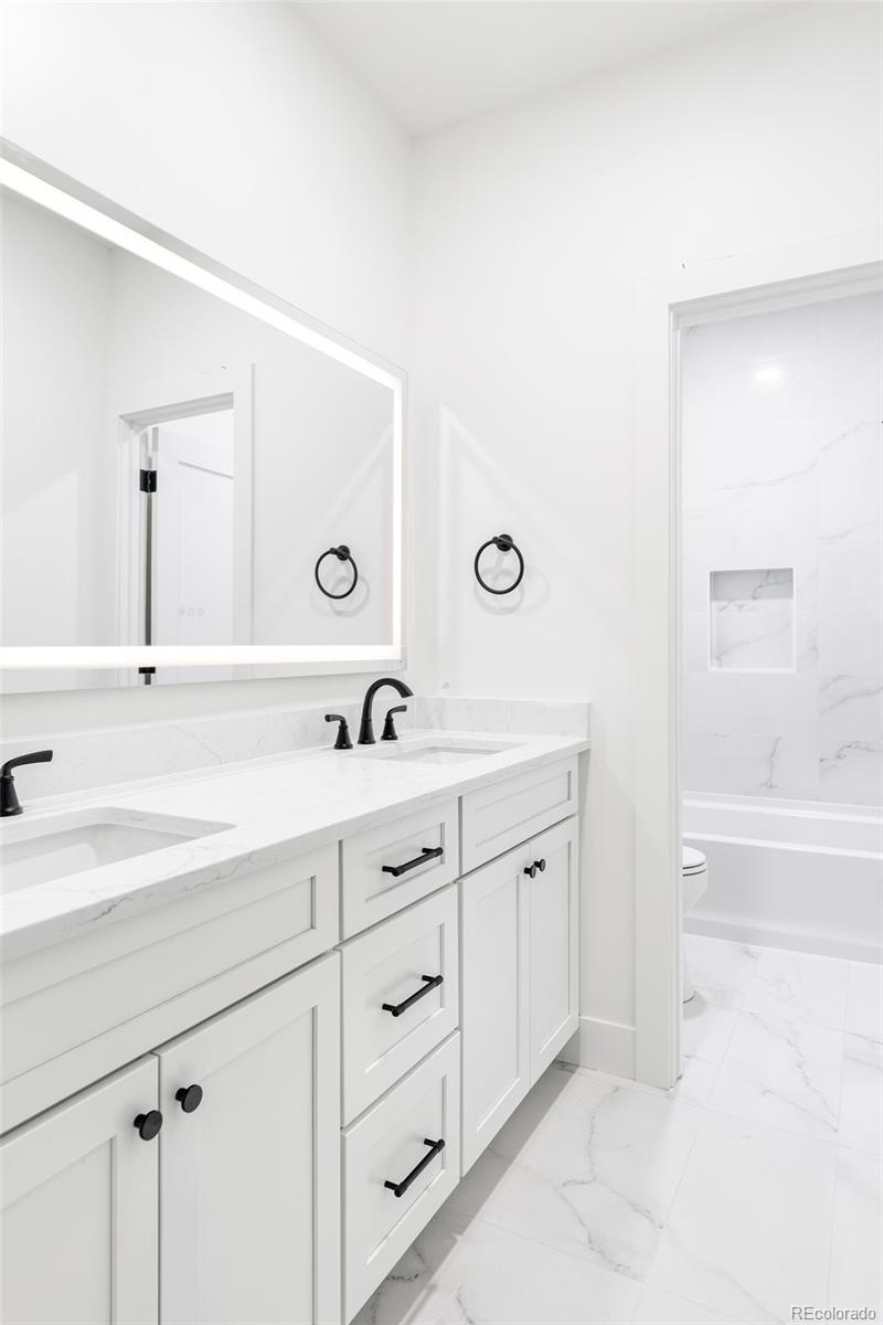 2914 Hooker Street Denver, CO 80211 - Photo 26 of 30 a spacious bathroom with a double vanity sink and mirror