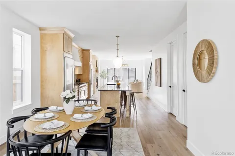 a dining room with furniture a rug and wooden floor