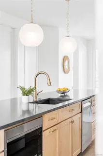 a kitchen with a sink and a white cabinets
