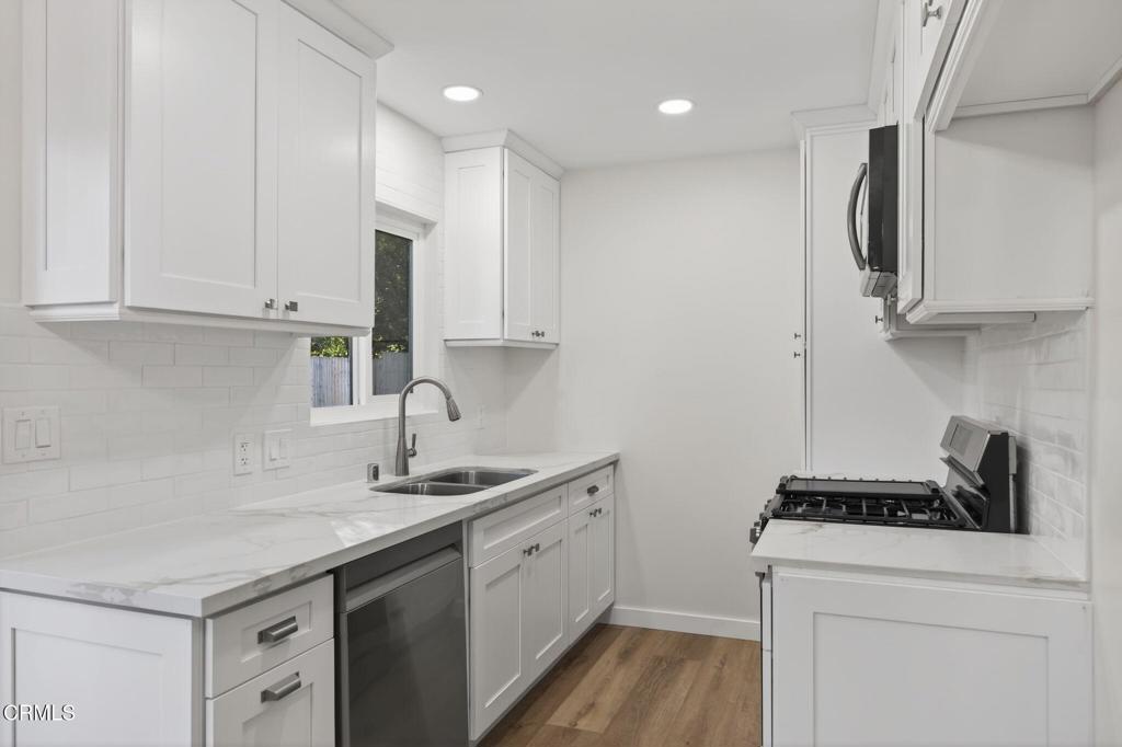 312 Prospect Street Oak View, CA 93022 - Photo 11 of 45 a kitchen with a sink stove and cabinets