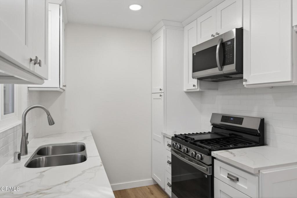 312 Prospect Street Oak View, CA 93022 - Photo 12 of 45 a kitchen with stainless steel appliances a stove a microwave and sink