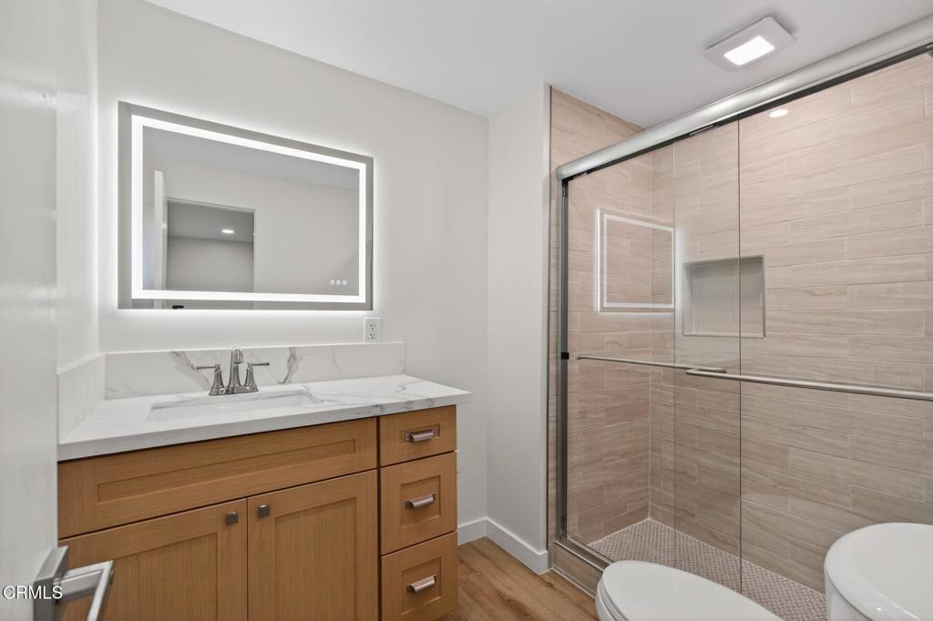 312 Prospect Street Oak View, CA 93022 - Photo 15 of 45 a bathroom with a sink toilet a mirror and shower