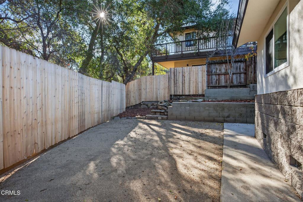 312 Prospect Street Oak View, CA 93022 - Photo 24 of 45 a view of a wooden door with a house and a trees in the background