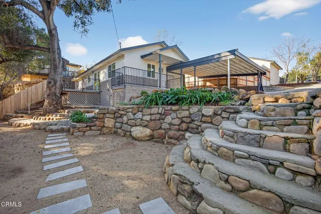 a view of backyard of house with outdoor seating