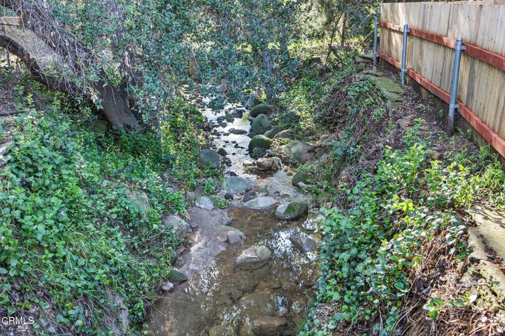 312 Prospect Street Oak View, CA 93022 - Photo 32 of 45 a view of a house with a lush green forest