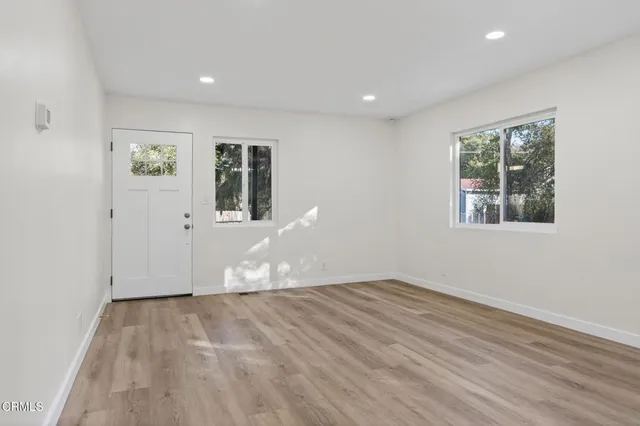 a kitchen with a sink cabinets stainless steel appliances and a large window