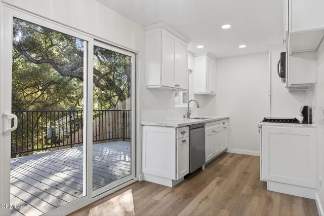 a kitchen with a sink stove and cabinets