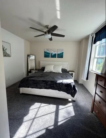 a bathroom with a granite countertop sink a toilet a mirror and vanity