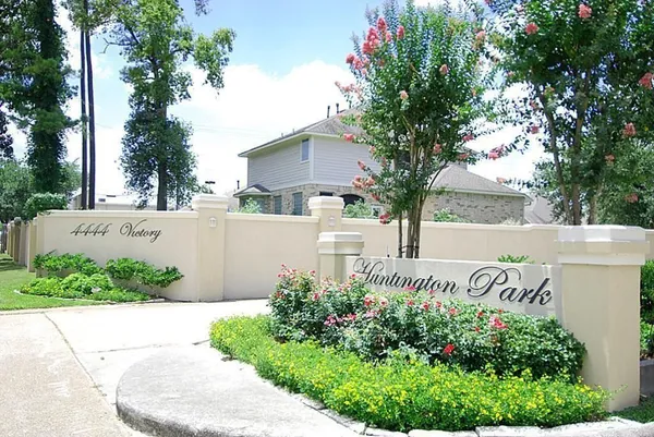 a sign that is in front of flowers