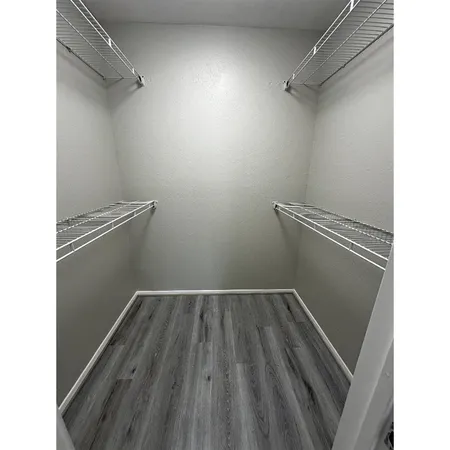 a view of a room with wooden floor