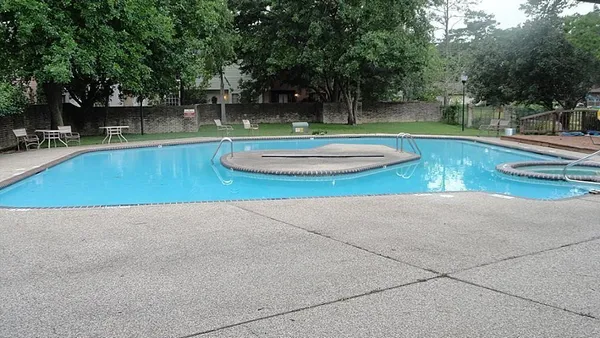 a view of a swimming pool with a patio