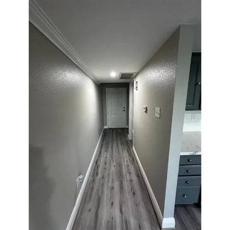 a view of hallway with wooden floor