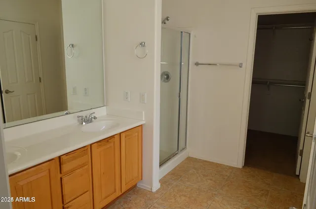 a bathroom with a double vanity sink and a mirror