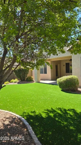 a view of a house with a backyard