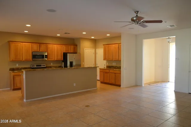 a kitchen with stainless steel appliances a refrigerator sink and cabinets