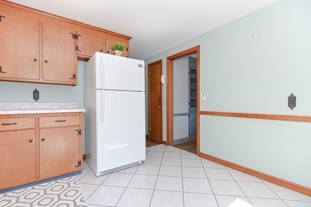 157 Vincent Road Dedham, MA 02026 - Photo 12 of 38 a white refrigerator freezer sitting in a kitchen