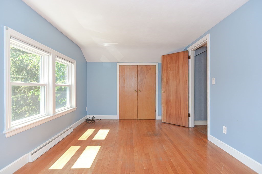 157 Vincent Road Dedham, MA 02026 - Photo 28 of 38 a view of hallway with a large window and wooden floor