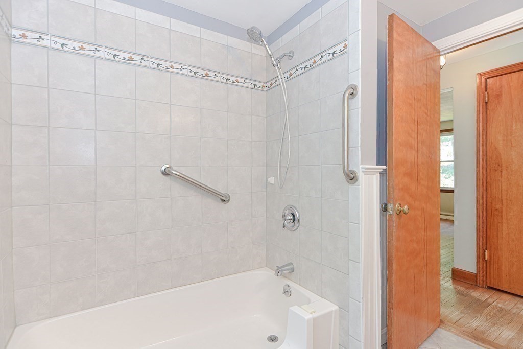 157 Vincent Road Dedham, MA 02026 - Photo 34 of 38 a bathroom with a shower and a bath tub