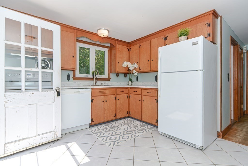 157 Vincent Road Dedham, MA 02026 - Photo 10 of 38 a white refrigerator freezer sitting inside of a kitchen