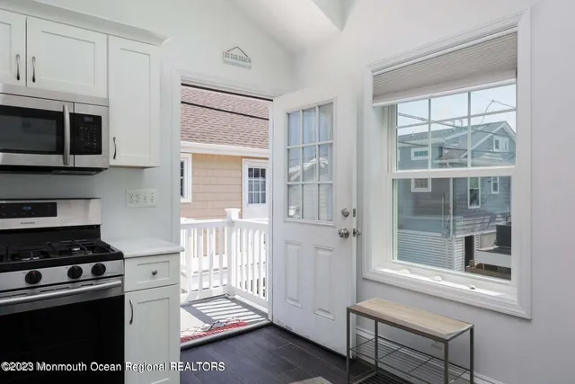 a kitchen that has a lot of cabinets in it and wooden floors