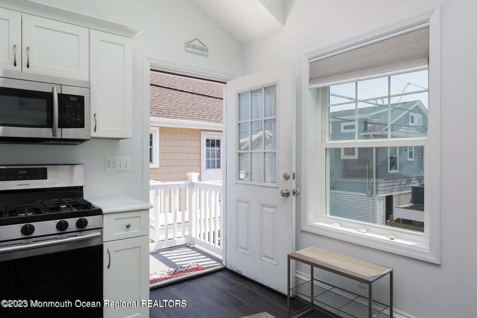 118 West Tide Way Lavallette, NJ 08735 - Photo 3 of 14 a kitchen with stainless steel appliances a stove a microwave and cabinets