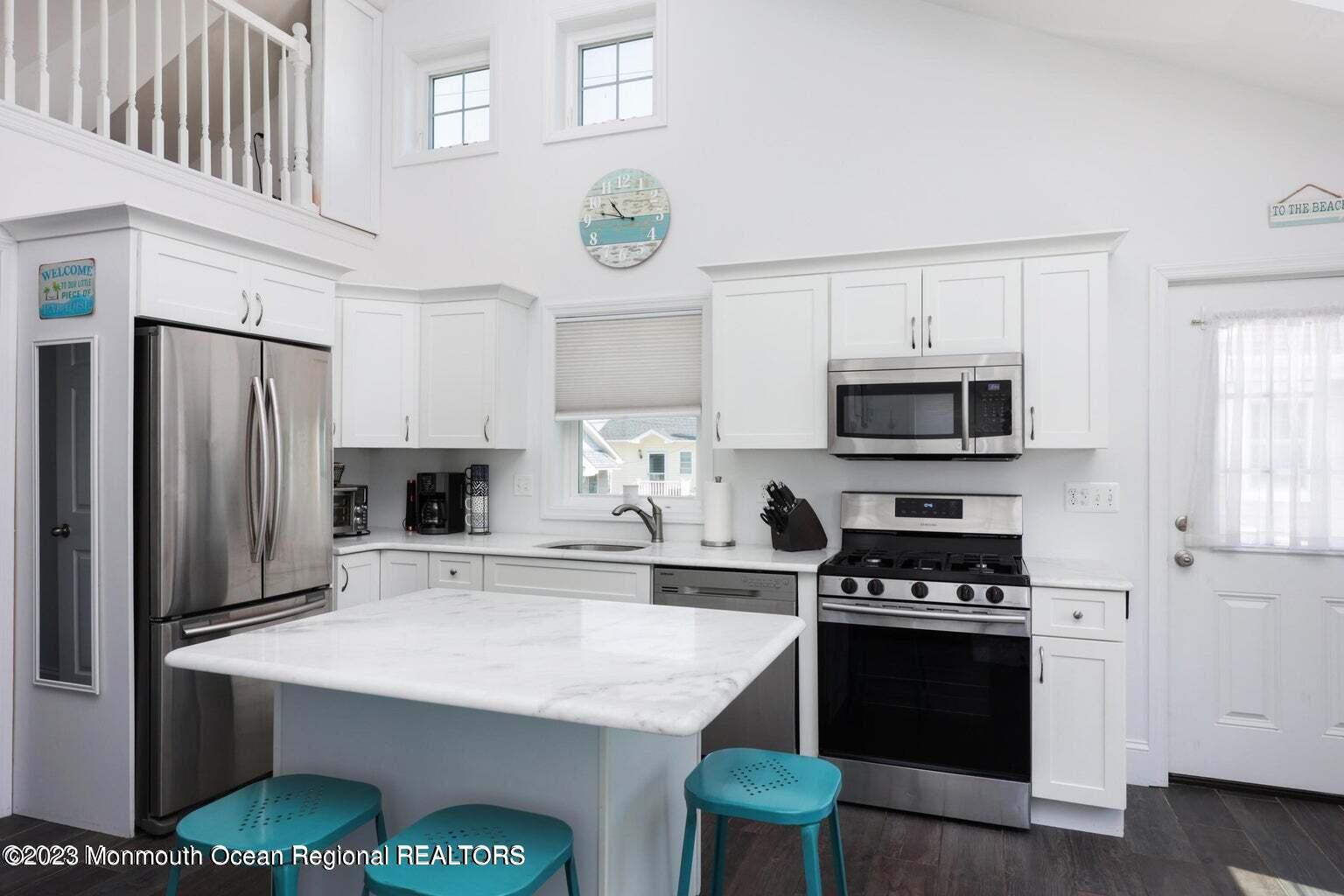 118 West Tide Way Lavallette, NJ 08735 - Photo 6 of 14 a kitchen with stainless steel appliances a stove a sink cabinets and a refrigerator