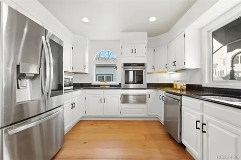 a kitchen with stainless steel appliances granite countertop a refrigerator sink and cabinets