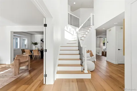 a view of entryway and hall with wooden floor