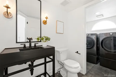 a bathroom with a sink toilet and a mirror
