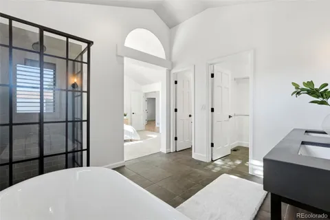 a spacious bedroom with a bed and a table