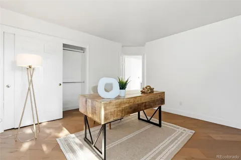 a view of a workspace with furniture and wooden floor
