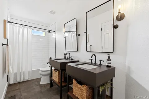 a bathroom with double sink and a mirror