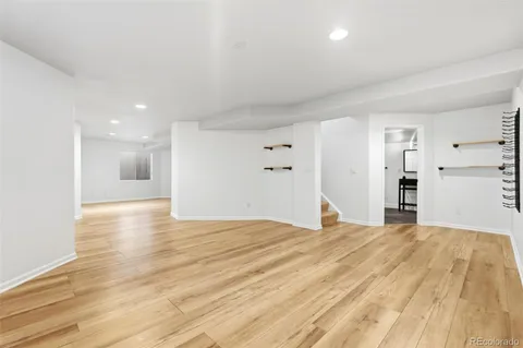 a view of empty room with wooden floor