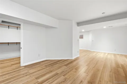 a view of empty room with wooden floor