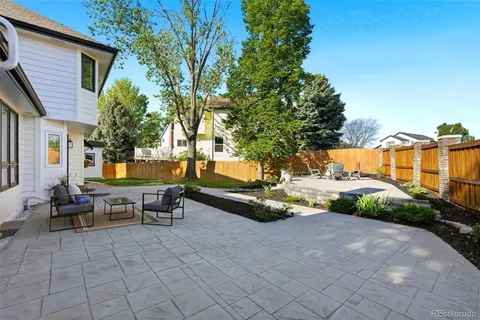 a backyard of a house with table and chairs